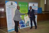 Prof. Jonathan Nzuma receiving a gift from Sam after the launch of Global Food Policy Report  2024